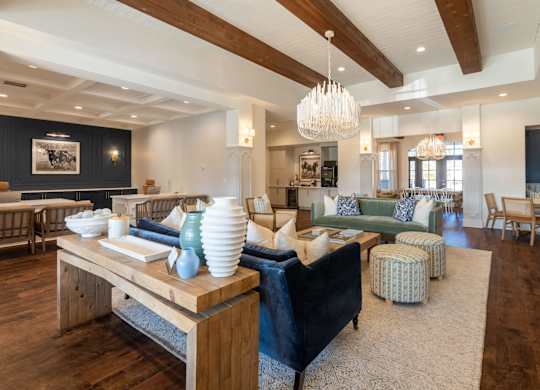A modern living room with a wooden floor and a large chandelier.