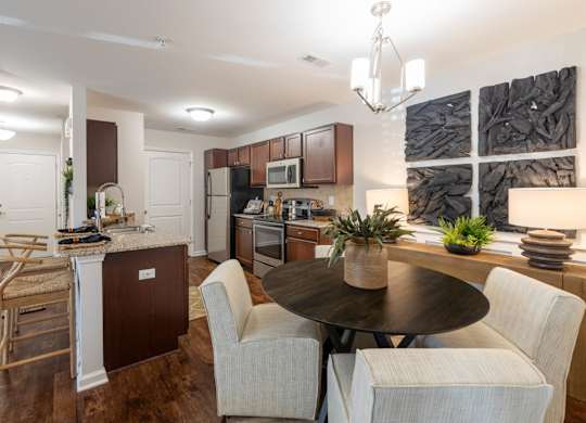 A modern kitchen with a dining table and chairs.