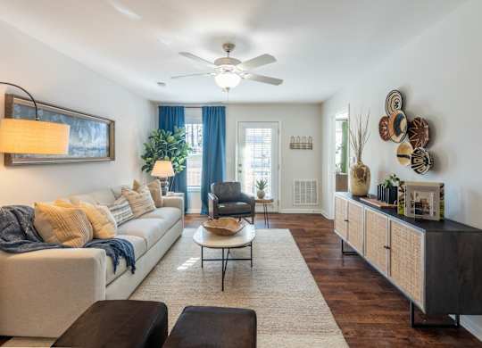 A living room with a white couch and a coffee table.