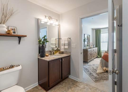 A bathroom with a white tub and a brown vanity.
