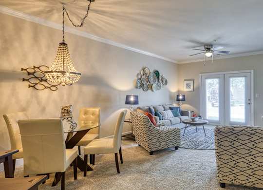 A living room with a dining table and chairs.