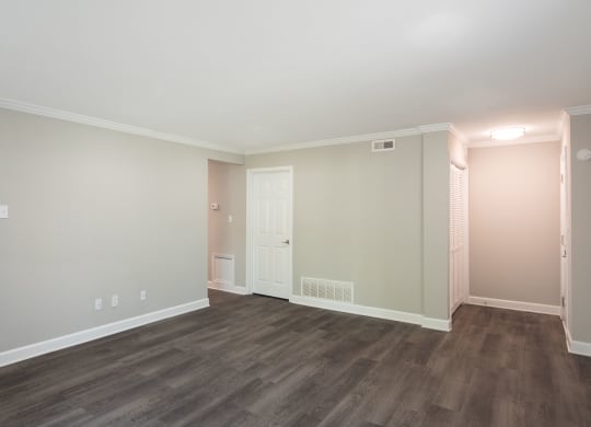 a bedroom with hardwood floors and grey walls