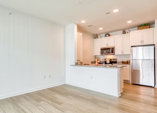 a kitchen with white cabinets and a stainless steel refrigerator at Allure at Edinburgh, Chesapeake, VA