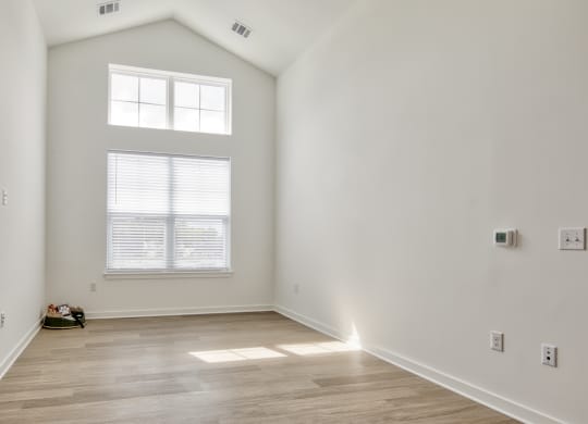an empty room with white walls and a window at Allure at Edinburgh, Chesapeake, VA, 23322