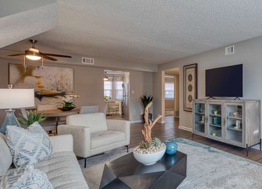 A living room with a couch, chair, and a coffee table.