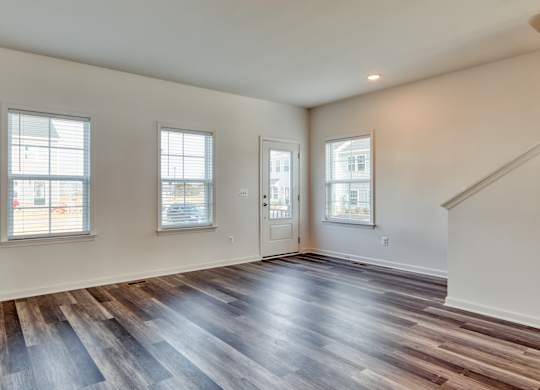 Living room with a large window and a wooden floor at The Mark, Harrisonburg, VA, Virginia