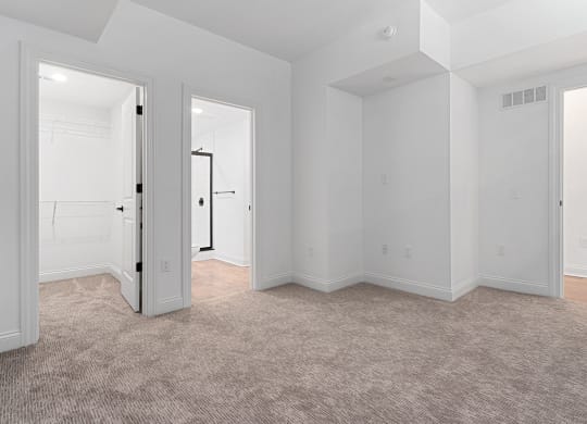 an empty living room with white walls and carpet at The Madison, Ohio, 43215