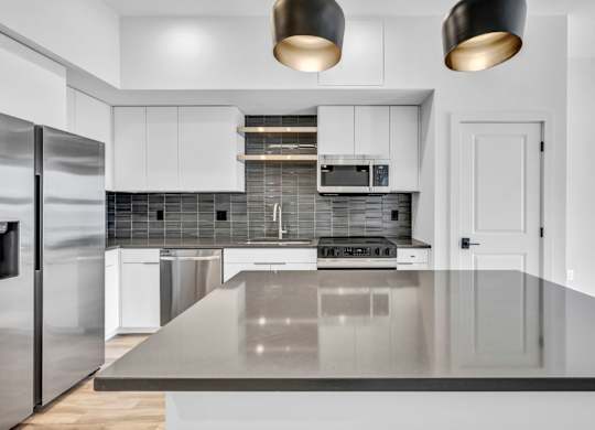 A modern kitchen with a large island in the middle.