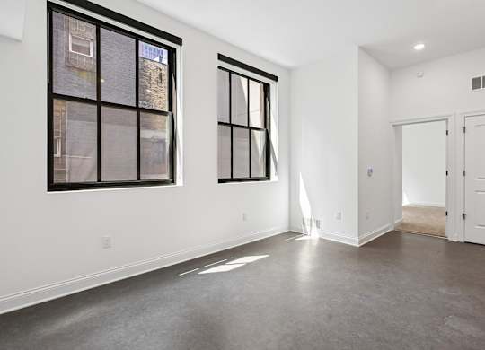 A room with a large window and a door.