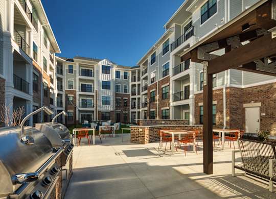 A sunny day at the outdoor seating area of a modern apartment complex.