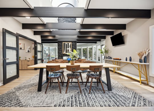 a large dining room with a large wooden table and chairs