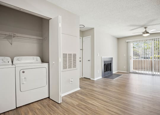 a laundry room with a washer and dryer and a fireplace