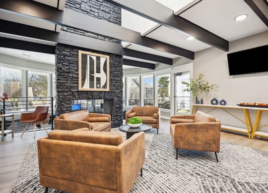 a living room with couches and chairs and a television