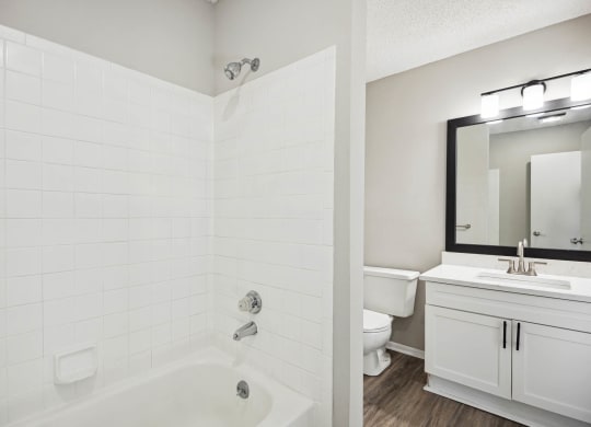 a bathroom with a shower and a sink and a toilet