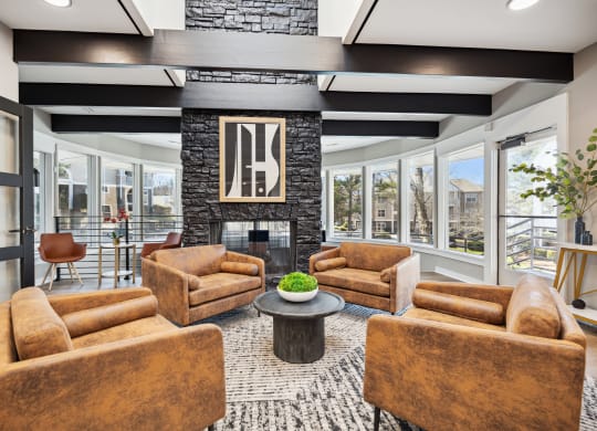 a living room with couches and chairs and a fireplace