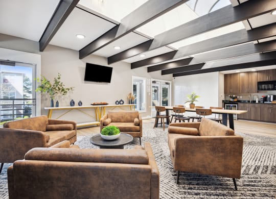 a living room with couches and chairs and a table