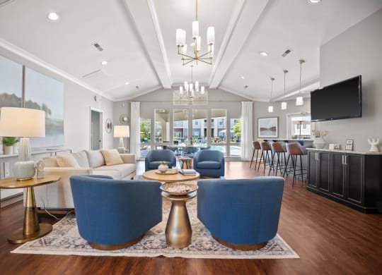 a living room with blue chairs and couches