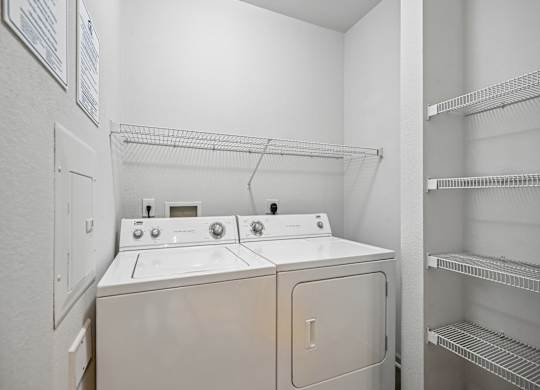 A white washer and dryer in a laundry room.