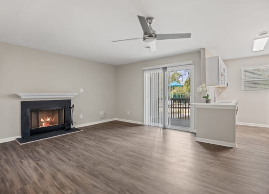 a living room with a fireplace and a door to a balcony