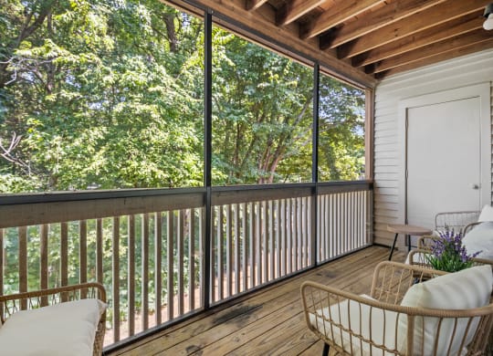 a porch with a couch and chairs and a sliding glass door