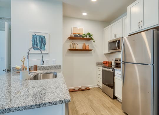 a kitchen with stainless steel appliances and granite counter tops