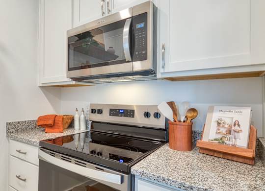 a kitchen with granite counter tops and a stove and microwave