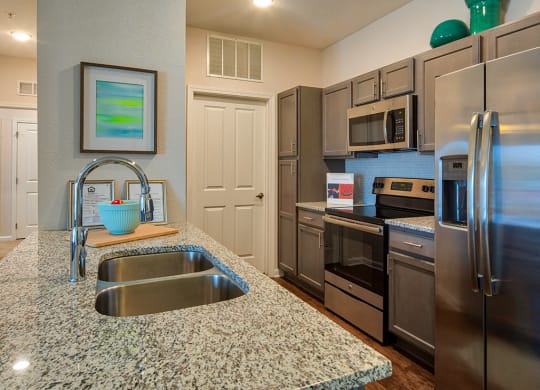 Kitchen with granite counters at The Choices Apartments
