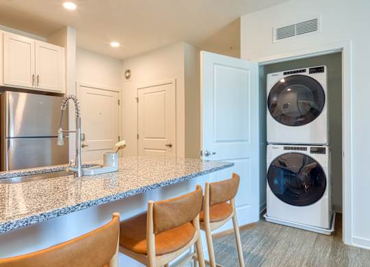 a kitchen with a counter top and a washer and dryer