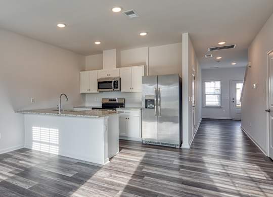 Modern kitchen with a refrigerator, microwave, and oven at The Mark, Virginia, 22801
