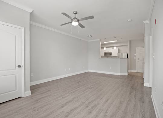 A room with a ceiling fan and light fixture.