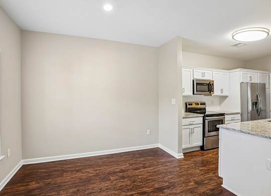 A kitchen with white cabinets and stainless steel appliances.