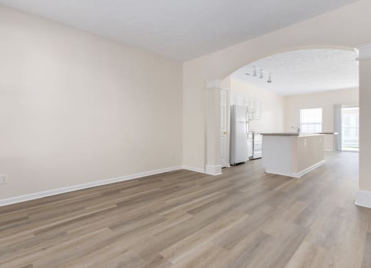 an empty living room and kitchen with white walls and wood flooring at Orleans Apartments Apartments, Columbus, OH, 43221