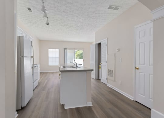an empty kitchen with a sink and a refrigerator at Orleans Apartments Apartments, Columbus, OH