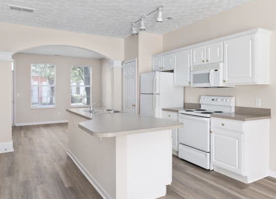 an open kitchen with white cabinets and appliances and a counter top at Orleans Apartments Apartments, Columbus, OH, 43221