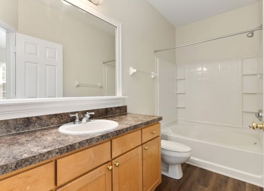 a bathroom with a sink and a toilet and a shower  at Orleans Apartments, Columbus, 43221