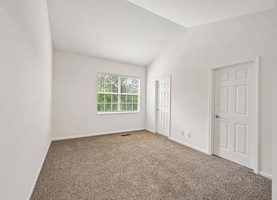 A room with a window and a door.