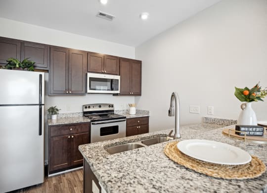 a kitchen with granite counter tops and stainless steel appliances