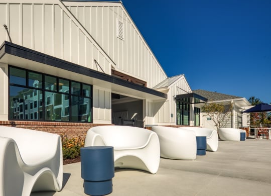 a row of white chairs in front of a building