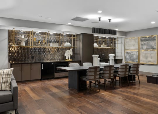 a dining room with a large table and chairs and a kitchen with a bar at Preston Centre, Ohio, 43215