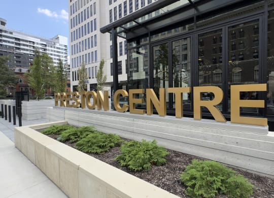 a building with a large golden sign on the front of it at Preston Centre, Columbus