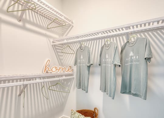 a laundry room with four shirts hanging on the wall at Allure at Edinburgh, Virginia, 23322