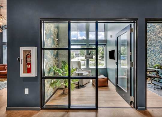 A modern interior with a glass door leading to a balcony.