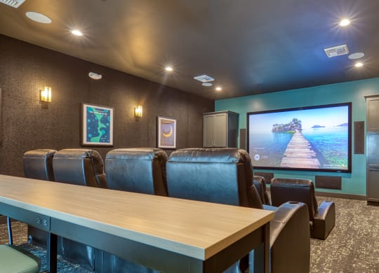 a conference room with a table and chairs and a tv on the wall at Allure at Edinburgh, Virginia, 23322