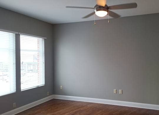 a living room with a ceiling fan and a window