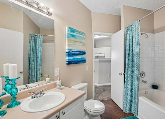 A bathroom with a white toilet, a white sink, and a white bathtub.
