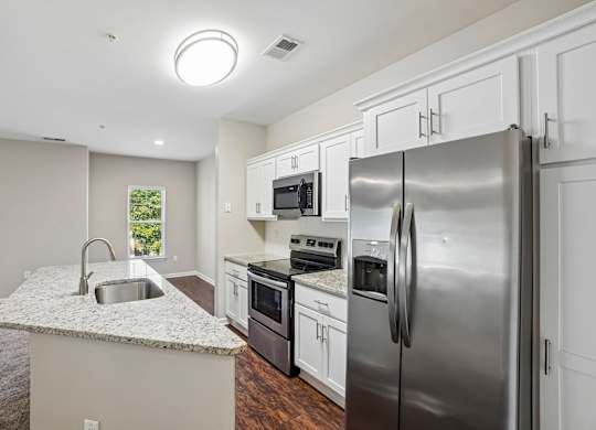 A modern kitchen with stainless steel appliances and a granite countertop.