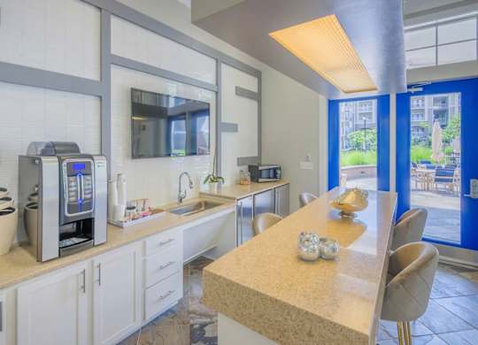 A kitchen with a table and chairs in front of a window.