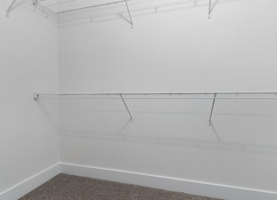 a room with a white wall and a hanging rack on the ceiling at Strathmoor Apartments , Dublin, Ohio