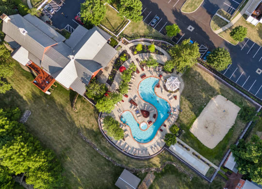an overhead view of a swimming pool in a backyard with a house and a neighborhood at The Charleston, Columbus
