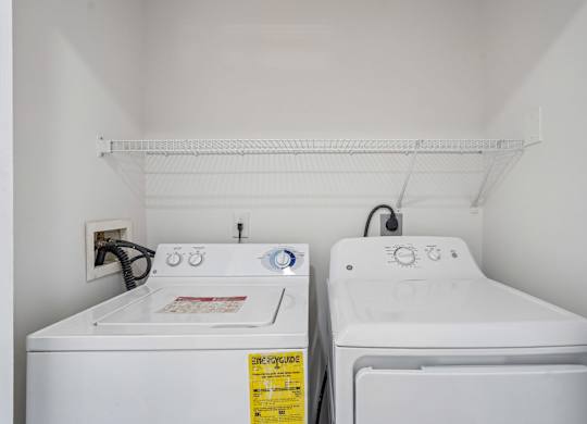 A small laundry room with a washer and dryer.